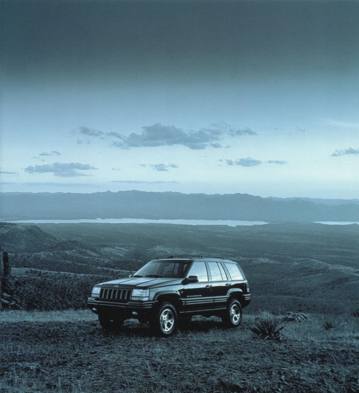 Grand Cherokee at dusk on a mountain ridge