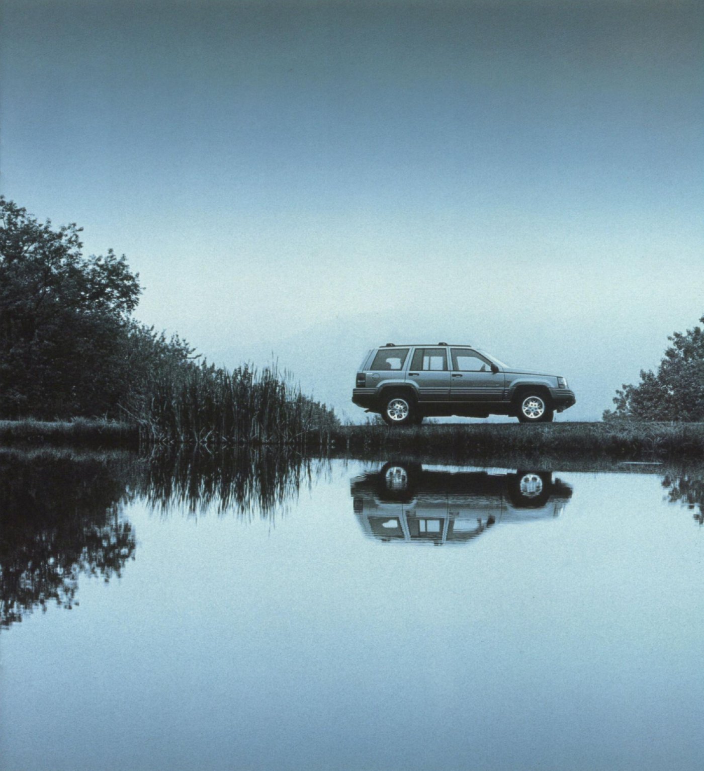 Grand Cherokee reflected in still water